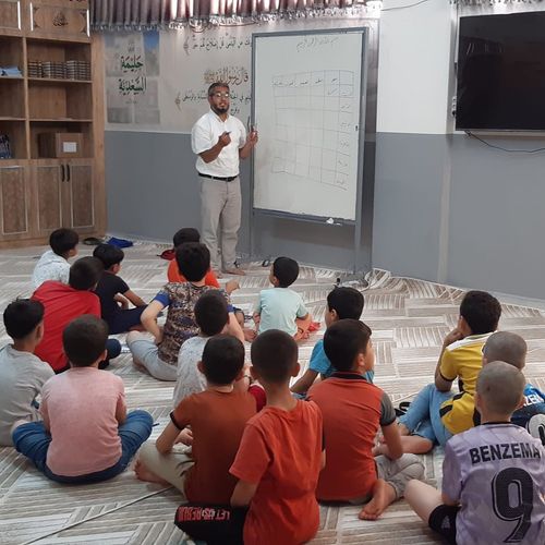 Our curious students listening to their teacher.